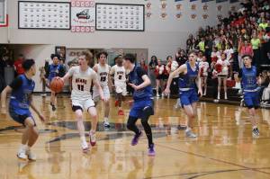 Juneau-Douglas High School: Yadaa.at Kalés Sean Oliver brings the ball up the court during the teams regular season finale game against Thunder Mountain High School at JDHS on Feb. 24. (Mark Sabbatini / Juneau Empire file photo)
