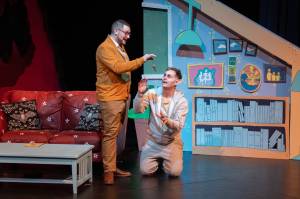 Steven Arends (left) feeds Joshua Midgett in Juneau Ghost Light Theatres production of Bat Boy: The Musical, which is being staged through March 17 at Thunder Mountain High School. (Cam Byrnes/ Juneau Ghost Light Theatre)