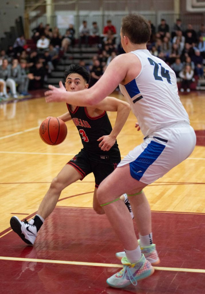 Juneau-Douglas High School: Yadaa.at Kalé senior Alwen Carrillo (3) drives against Thunder Mountain senior James Polasky (24) during the boys championship game of the Alaska Airlines Region V 4A Basketball Tournament on Friday at Mt. Edgecumbe High Schools B.J. McGillis Gymnasium in Sitka. (James Poulson/Daily Sitka Sentinel)