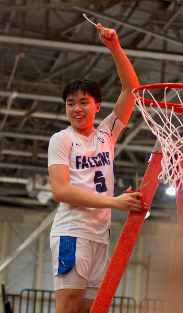 Thunder Mountain senior TJ Guevarra (5) cuts the net after the Falcons defeated the Juneau-Douglas High School: Yadaa.at Kalé Crimson Bears 63-58 in the championship game of the Alaska Airlines Region V 4A Basketball Tournament on Friday at Mt. Edgecumbe High Schools B.J. McGillis Gymnasium in Sitka. (James Poulson/Daily Sitka Sentinel)