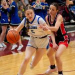 Thunder Mountain senior Jenna Dobson (5) dribbles past Juneau-Douglas High School: Yadaa.at Kalé junior Nadia Wilson during the Falcons 56-49 win over the Crimson Bears in the championship game of the Alaska Airlines Region V 4A Basketball Tournament on Friday at Mt. Edgecumbe High Schools B.J. McGillis Gymnasium in Sitka. (James Poulson/Daily Sitka Sentinel)
