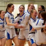 The Thunder Mountain High School Falcons girls basketball team celebrate their 56-49 win over the Juneau-Douglas High School: Yadaa.at Kalé Crimson Bears in the championship game of the Alaska Airlines Region V 4A Basketball Tournament on Friday at Mt. Edgecumbe High Schools B.J. McGillis Gymnasium in Sitka. (James Poulson/Daily Sitka Sentinel)