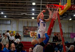 Thunder Mountain High School freshman Bergen Erickson (12) cuts the net after the Falcons defeated the Juneau-Douglas High School: Yadaa.at Kalé Crimson Bears 56-49 in the championship game of the Alaska Airlines Region V 4A Basketball Tournament on Friday at Mt. Edgecumbe High Schools B.J. McGillis Gymnasium in Sitka. (James Poulson/Daily Sitka Sentinel)
