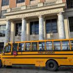 A school bus passes in front of the Alaska State Capitol on Feb. 6. (James Brooks/Alaska Beacon)