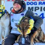 Dallas Seavey sits with his lead dogs Sebastian, left, and Aero after his sixth Iditarod Trail Sled Dog Race win on Tuesday in Nome. (Anne Raup/Anchorage Daily News via AP)