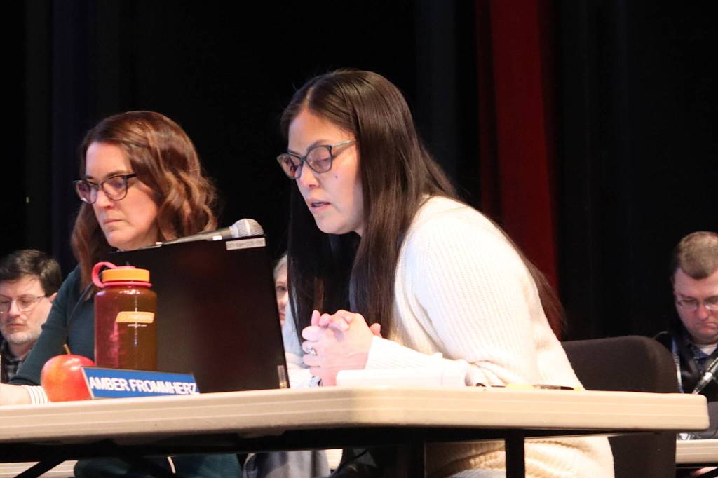 Amber Frommherz, a Juneau Board of Education member, presents her proposal for two local schools for students in grades 8-12 during a meeting Tuesday evening at Juneau-Douglas High School: Yadaa.at Kalé. (Mark Sabbatini / Juneau Empire)
