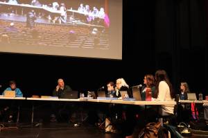 The Juneau Board of Education debates a school district consolidation plan after midnight Wednesday, near the end of an eight-hour meeting at the Juneau-Douglas High School: Yadaa.at Kalé auditorium. (Mark Sabbatini / Juneau Empire)