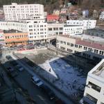 For several years the site of the burned C.W. Young store was an idle eyesore. Here a raven is silhouetted against the snow-covered ground as it flies above the pit. The space would be developed into the Walter Soboleff Building. Dr. Soboleff was of the Raven moiety. (Photo by Brian Wallace)