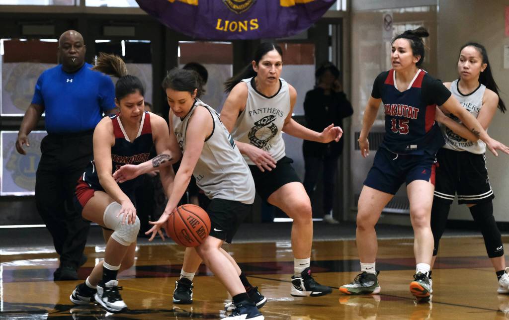 Yakutats Trinity Jackson and POWs Michaela Demmert battle for a ball as POWs Tina Steffen, Yakutats Lorena Williams and POWs Lillian Borromeo look on during the Gold Medal Basketball Tournament on Saturday, March 25, 2023, at Juneau-Douglas High School: Yadaa.at Kalé. (Klas Stolpe/For the Juneau Empire)