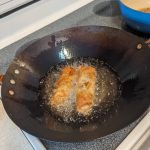 Crispy shrimp spring rolls frying. (Photo by Patty Schied)