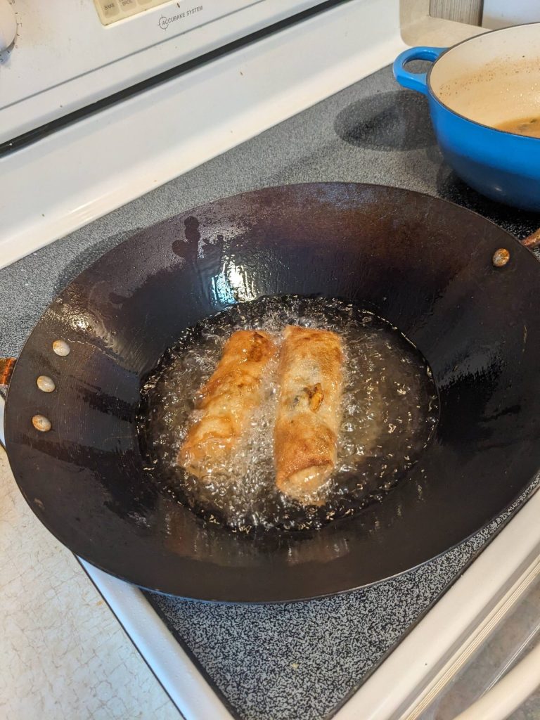 Crispy shrimp spring rolls frying. (Photo by Patty Schied)