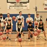 The Thunder Mountain High School Falcons Region V champion boys basketball team pose for a photo during practice at the Thunderdome on Friday. The Falcons begin state tournament play Wednesday at Anchorages Alaska Airlines Center. (Klas Stolpe / For the Juneau Empire)