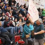 Archie Lee waves a flag rooting for Hoonah during the communitys C bracket game against Metlakatla on Sunday at Juneau-Douglas High School: Yadaa.at Kalé. (Mark Sabbatini / Juneau Empire)