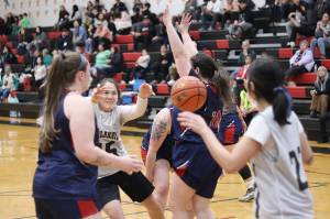 Metlakatlas Drena Hayward (#15) passes the ball to a teammate in their opening game against Yakutat during the 75th Gold Medal Basketball Tournament on Sunday morning at Juneau-Douglas High School: Yadaa.at Kalé. (Mark Sabbatini / Juneau Empire)