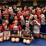 The Juneau-Douglas High School: Yadaa.at Kalé Crimson Bears and Thunder Mountain Falcons cheer teams pose with their champion and runner-up trophies on Tuesday at the 2024 ASAA/First National Bank Alaska Cheer State Championships at the Alaska Airlines Center in Anchorage. (Klas Stolpe, For the Juneau Empire)