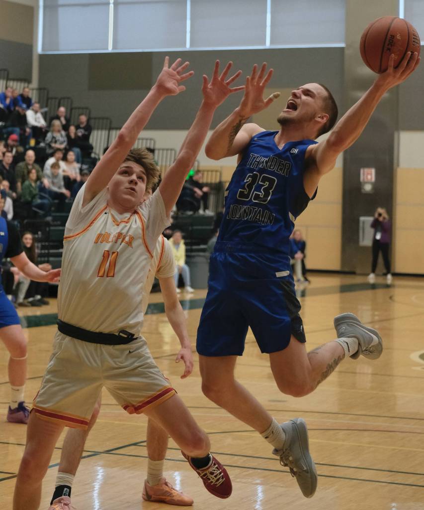Thunder Mountain senior Thomas Baxter (33) shoots over West Valley senior Leyton Nield (11) during the Falcons 53-51 overtime win against the Wolfpack in the 2024 ASAA March Madness Alaska 4A Boys Basketball State Championships on Wednesday at Anchorages Alaska Airlines Center. (Klas Stolpe for the Juneau Empire)
