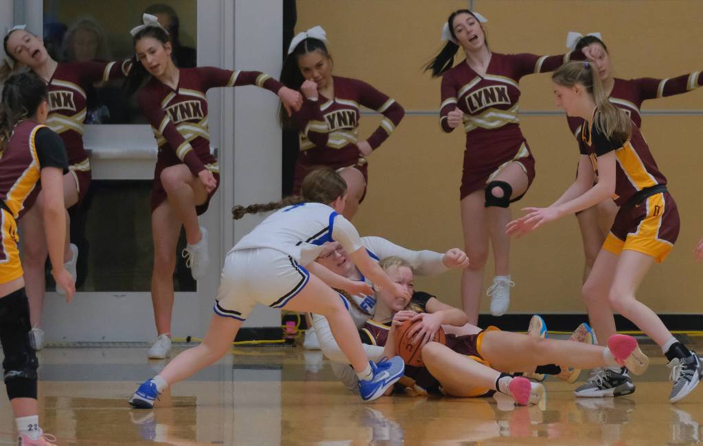 Thunder Mountain sophomore Cambry Lockhart (1) and senior Kara Strong battle for a loose ball with Dimond junior Evan Hamey during the Falcons 58-47 win over the Lynx in the 2024 ASAA March Madness Alaska 4A Girls Basketball State Championships on Wednesday at Anchorages Alaska Airlines Center. (Klas Stolpe / For the Juneau Empire)