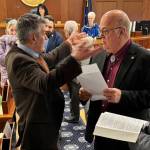 Rep. Andrew Gray, D-Anchorage, gestures with his hands as he talks to Rep. Kevin McCabe, R-Big Lake, about an amendment to raise the states age of consent on Friday in the Alaska House of Representatives. (Photo by James Brooks/Alaska Beacon)