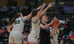 Thunder Mountain High School junior Cailynn Baxter (23) powers a shot against Colony junior Tonya Karpow, freshman Jericho Wuestenberg and junior Alycia Shelley during the Falcons 69-35 semifinal loss to the Knights at the 2024 ASAA March Madness Alaska 4A Girls Basketball State Championships on Friday at Anchorages Alaska Airlines Center. (Klas Stolpe / For the Juneau Empire)