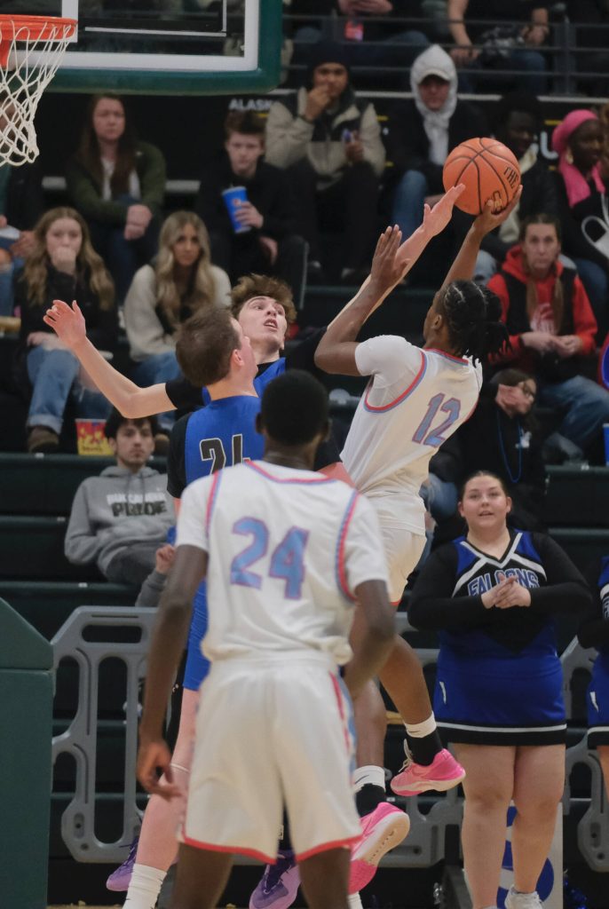 Thunder Mountain senior Kasen Ludeman blocks a shot by East senior Akeem Sulaiman (12) as Falcons teammate James Polask moves in during the Falcons 60-34 loss to the Thunderbirds in the title game of the 2024 ASAA March Madness Alaska 4A Boys Basketball State Championships on Saturday at Anchorages Alaska Airlines Center. (Klas Stolpe / For the Juneau Empire)