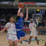 Thunder Mountain senior Samuel Lockhart (14) scores over East senior Michael George (3) during the Falcons 60-34 loss to the Thunderbirds in the title game of the 2024 ASAA March Madness Alaska 4A Boys Basketball State Championships on Saturday at Anchorages Alaska Airlines Center. (Klas Stolpe / For the Juneau Empire)