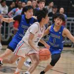 Thunder Mountain seniors TJ Guevarra (5) and Lance Nierra (1) defend East senior Michael George (3) during the Falcons 60-34 loss to the Thunderbirds in the title game of the 2024 ASAA March Madness Alaska 4A Boys Basketball State Championships on Saturday at Anchorages Alaska Airlines Center. (Klas Stolpe / For the Juneau Empire)