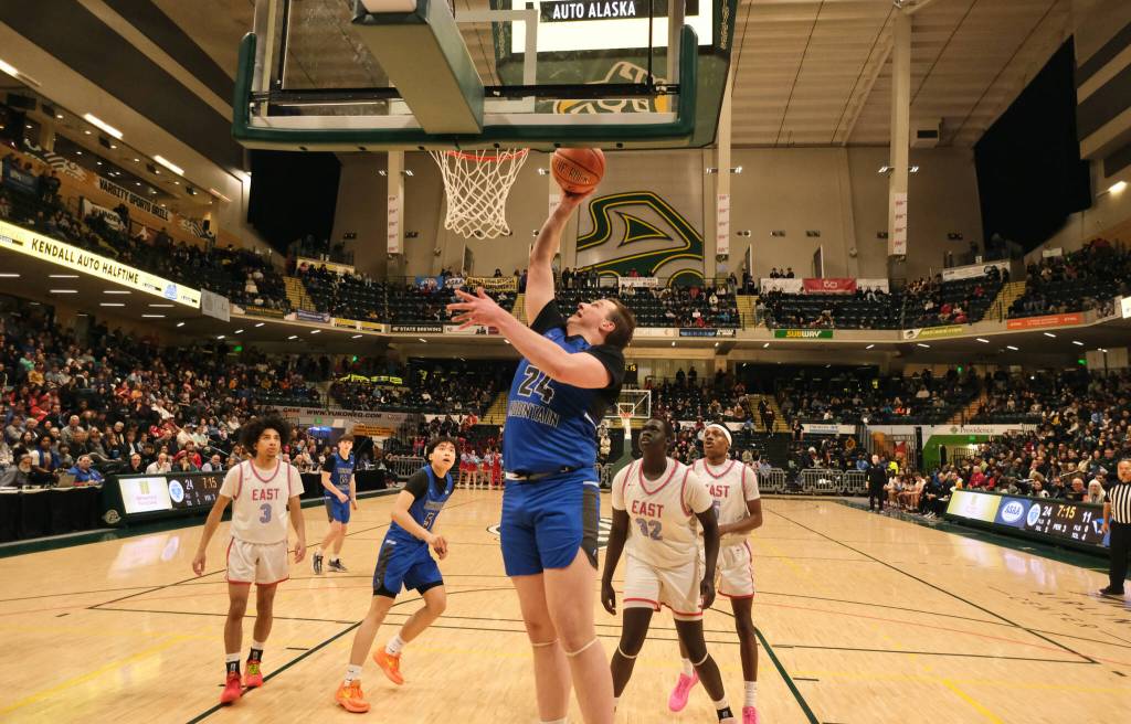 Thunder Mountain senior James Polasky (24) scores past East Anchorage junior Jal Tharjiath (32) during the Falcons 60-34 loss to the Thunderbirds in the title game of the 2024 ASAA March Madness Alaska 4A Boys Basketball State Championships on Saturday at Anchorages Alaska Airlines Center. (Klas Stolpe / For the Juneau Empire)
