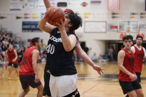 Angoons Levi Johnson Jr. takes a shot under the basket against Hydaburg during the B Bracket championship of the 75th Gold Medal Basketball Tournament on Saturday at Juneau-Douglas High School: Yadaa.at Kalé. (Mark Sabbatini / Juneau Empire)