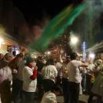 Dozens of people throw colors in the air and at each other during a Holi festival gathering Monday night outside Spice Juneau Indian Cuisine. (Mark Sabbatini / Juneau Empire)