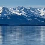Sun on the Chilkats reflects on Stevens Passage on March 21. (Photo by Denise Carroll)