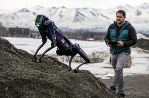 Alaska Department of Transportation program manager Ryan Marlow demonstrates the agencys robotic dog in Anchorage on March 26. The device will be camouflaged as a coyote or fox to ward off migratory birds and other wildlife at Alaskas second-largest airport, the DOT said. (Marc Lester/Anchorage Daily News via AP)