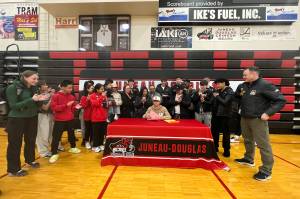 Alwen Carrillo, a senior at Juneau-Douglas High School: Yadaa.at Kalé, signs a letter of intent on Monday to play college basketball at Edmond College in Lynnwood, Washington. (Photo courtesy of Annie Lazo-Chappell)