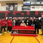 Alwen Carrillo, a senior at Juneau-Douglas High School: Yadaa.at Kalé, signs a letter of intent on Monday to play college basketball at Edmond College in Lynnwood, Washington. (Photo courtesy of Annie Lazo-Chappell)