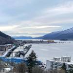 Looking south from downtown Juneau in December 2023 with buildings and docks in the foreground, the rock dump can be seen jutting into Gastineau Channel and providing a weather-protected harbor for Juneau. (Photo by Laurie Craig)