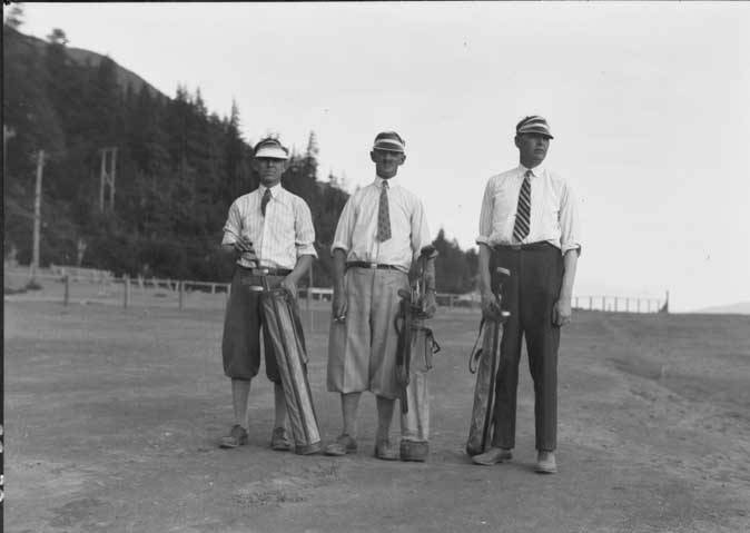 Governor George Parks (right), AELPs manager William Pullen (center) and an unidentified man (left) stand on the barren Million Dollar Golf Course made atop the waste rock from the A-J mine. There was no grass on fairways or greens. (ASL-P87-1261)