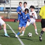 Thunder Mountain High Schools Fixx Siner (11) and Juneau-Douglas High School: Yadaa.at Kalés Kellen Chester (10) fight for the ball during Tuesdays season-opening game for both teams at TMHS. (Mark Sabbatini / Juneau Empire)