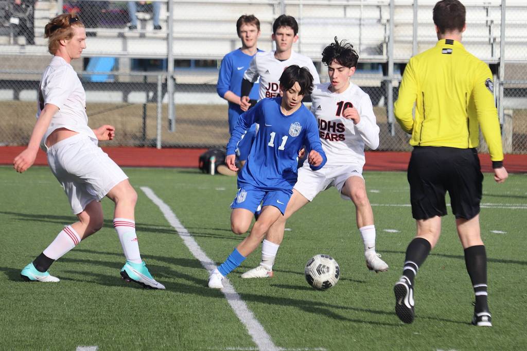 Thunder Mountain High Schools Fixx Siner (11) and Juneau-Douglas High School: Yadaa.at Kalés Kellen Chester (10) fight for the ball during Tuesdays season-opening game for both teams at TMHS. (Mark Sabbatini / Juneau Empire)