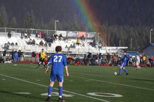 A rainbow connects with Kajson Cunningham (30) as he connects with the ball for Thunder Mountain High School during Tuesdays game against Juneau-Douglas High School: Yadaa.at Kalé at JDHS, the opening match of the season for both teams. (Mark Sabbatini / Juneau Empire)