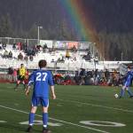 A rainbow connects with Kajson Cunningham (30) as he connects with the ball for Thunder Mountain High School during Tuesdays game against Juneau-Douglas High School: Yadaa.at Kalé at JDHS, the opening match of the season for both teams. (Mark Sabbatini / Juneau Empire)
