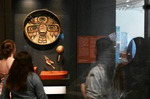 Visitors to the Denver Art Museum look at Drum (Gaaw), a cultural item from the Tlingit and Haida Indian Tribes of Alaska, on display in the Northwest Coast and Alaska Native Art Galleries on March 27. The tribes, from Southeast Alaska, have been trying to reclaim their cultural items from the Denver Art Museum for more than 30 years. (RJ Sangosti/The Denver Post)