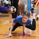 Maddy Fortunato, a Chickaloon middle school student, sets to attempt the one-hand reach by touching a suspended ball while remaining balanced on the other hand during the Traditional Games on Sunday at Juneau-Douglas High School: Yadaa.at Kalé. (Mark Sabbatini / Juneau Empire)