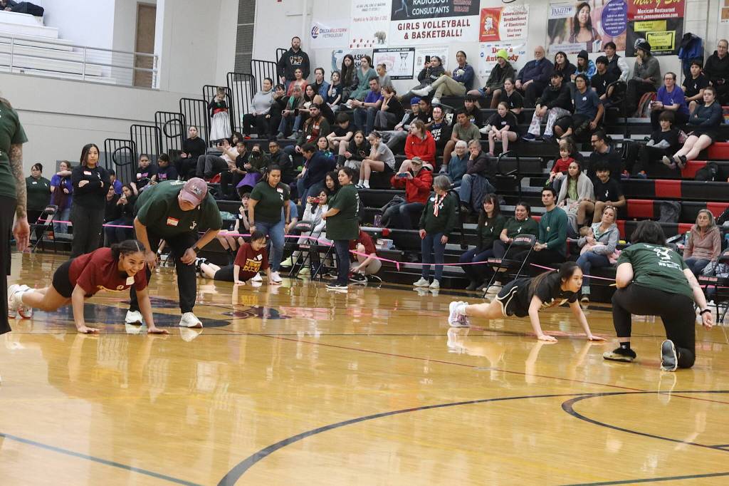 High school girls participate in the seal hop across the gymnasium floor at Juneau-Douglas High School: Yadaa.at Kalé during the Traditional Games on Sunday. (Mark Sabbatini / Juneau Empire)