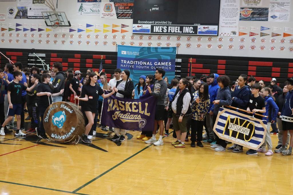 Members of about 30 student and adult teams greet each other while entering the gymnasium at Juneau-Douglas High School: Yadaa.at Kalé during the opening ceremony of the Traditional Games on Saturday. (Mark Sabbatini / Juneau Empire)