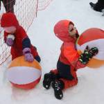 Adalee DiMarzio clutches a beach ball while her brother, Bryer, contemplates a chunk of snow as well as a ball during the Slush Cups beach party on Sunday at Eaglecrest Ski Area. (Mark Sabbatini / Juneau Empire)