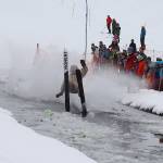 Brett Weideman wipes out while trying to cross the pond during his first Slush Cup at Eaglecrest Ski Area on Sunday. (Mark Sabbatini / Juneau Empire)