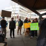 About 20 people gather in Marine Park at midday Tuesday for a rally calling for a ban on large cruise ships on Saturdays in Juneau. Some of the participants are members of a committee planning to gather signatures for a petition to put the question on the ballot for local voters. (Mark Sabbatini / Juneau Empire)