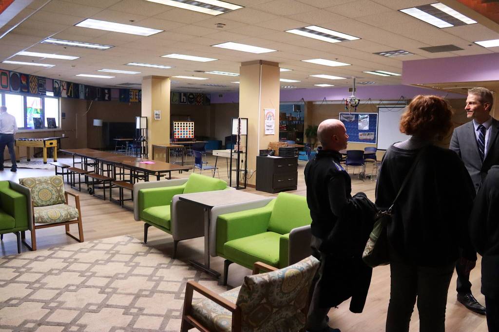 City and school district leaders examine the commons area in the Marie Drake Building, which could be converted to a new Assembly Chambers if selected as a new City Hall, during a tour on Thursday, April 4. (Mark Sabbatini / Juneau Empire)