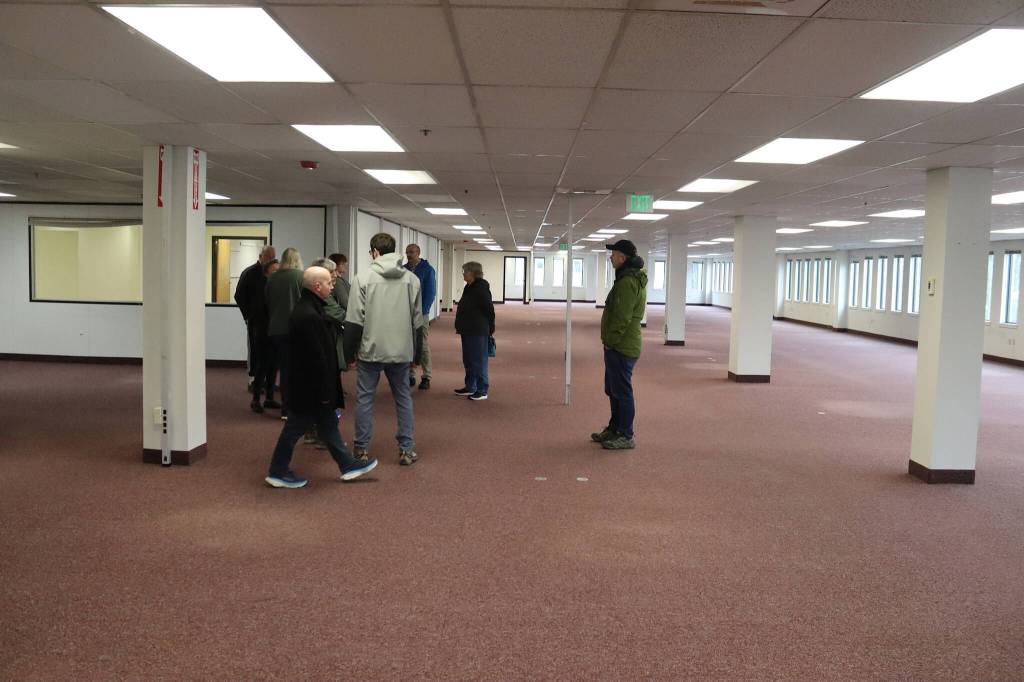 Assembly members and other visitors examine empty office space inside the Michael J. Burns Building on Monday, April 8, that city employees are scheduled to move into on May 1. (Mark Sabbatini / Juneau Empire)