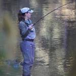 The authors wife fights a steelhead while the author contemplates fly selection. (Photo by Jeff Lund)
