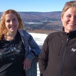 Astrophysicists Lindsay Glesener, left, and Sabrina Savage enjoy the sunshine on an observation deck at the Neil Davis Science Center on a hilltop at Poker Flat Research Range north of Fairbanks. (Photo by Ned Rozell)